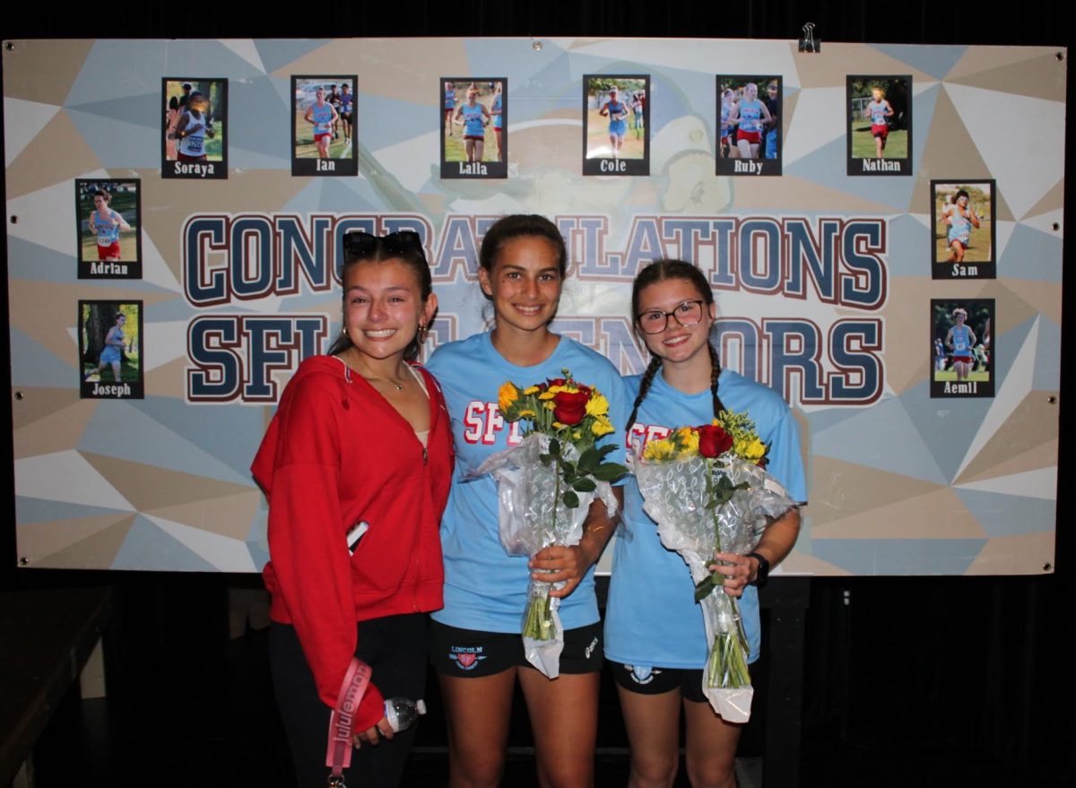  Laila Miller stands with fellow senior Soraya Luschas and junior Logan Sanborn at the cross-country senior night in the LHS little theater (photo used with permission by Jessie Miller)