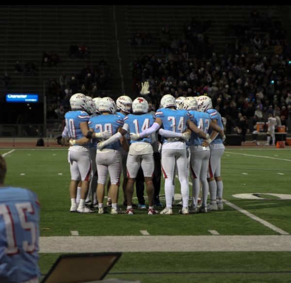 The LHS football team huddling during a time out. 