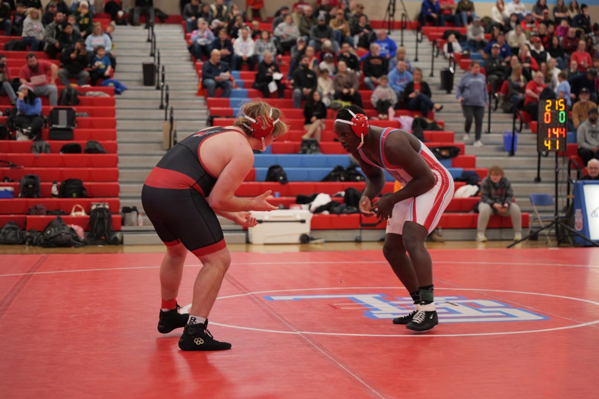 Senior Kishmar Eberline faces a Yankton High School wrestler.