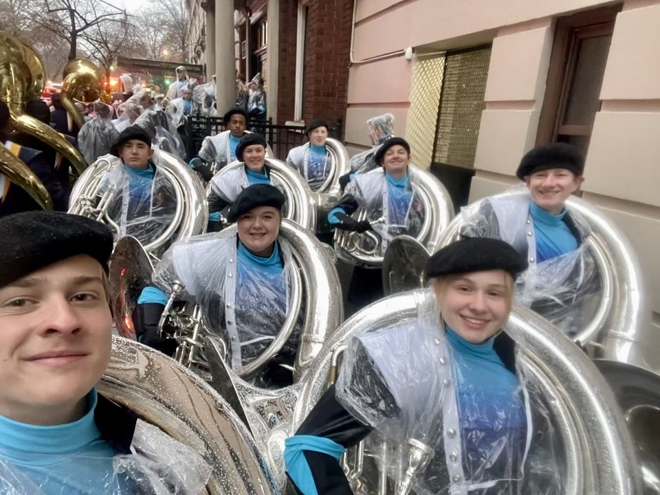 The tubas march down a side street after they finish performing in the parade. 