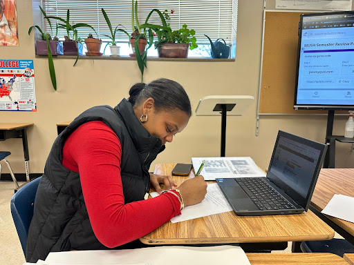 Junior Achalla Akway preparing for her MUSH semester test by filling out the semester review packet.