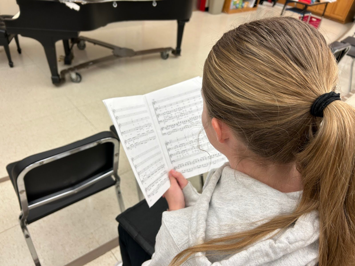 LHS junior Ella Bartz reading music for their spring masterworks concert.