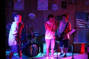 Guitarists Peter Stys (left) and James Heiman (right) play the bassline while Braxon Boyd (middle) sings. 
Used with permission by Peter Stys 