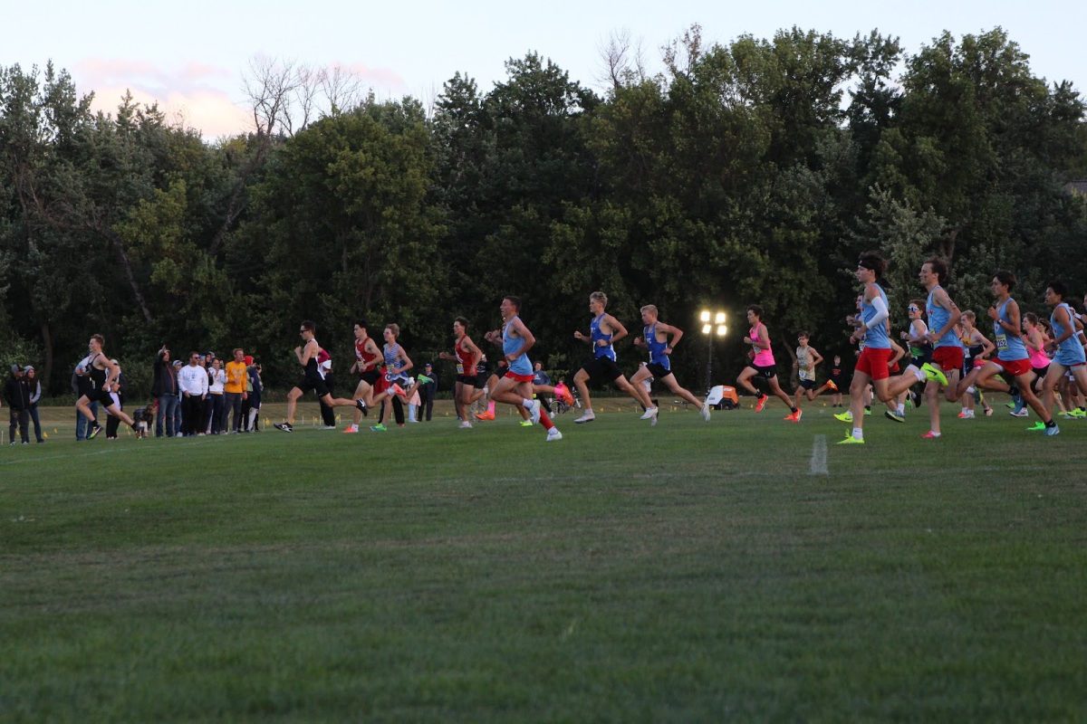 The boys junior varsity team moves in front of their competitors as a pack when the four-kilometer race commences.