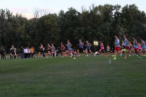 The boys junior varsity team moves in front of their competitors as a pack when the four-kilometer race commences.