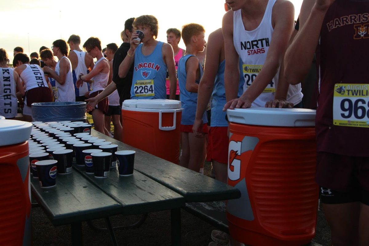 After completing the junior varsity four-kilometer race, LHS boys runners huddle around the water table.
