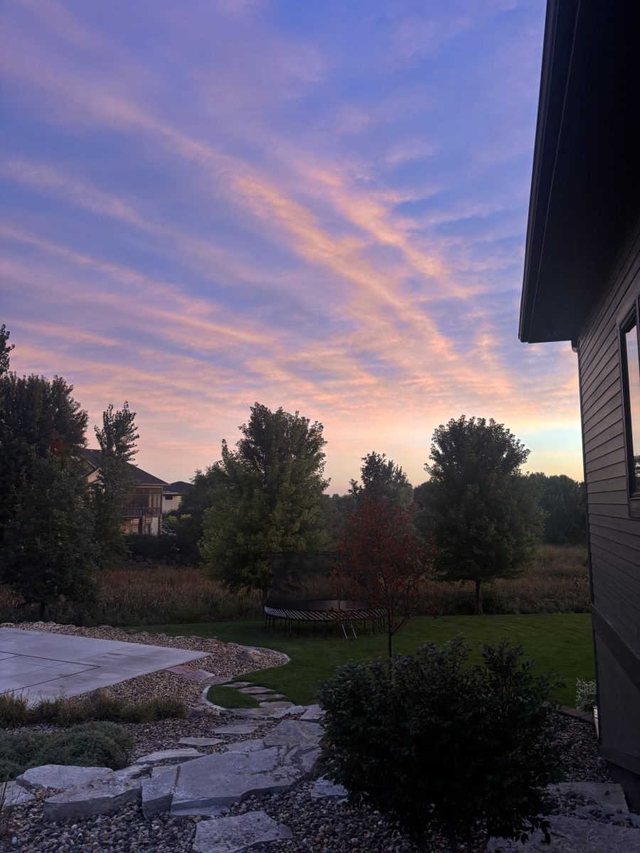 As the sun sets on a fall evening it creates colorful streaks of pink and orange in the sky.