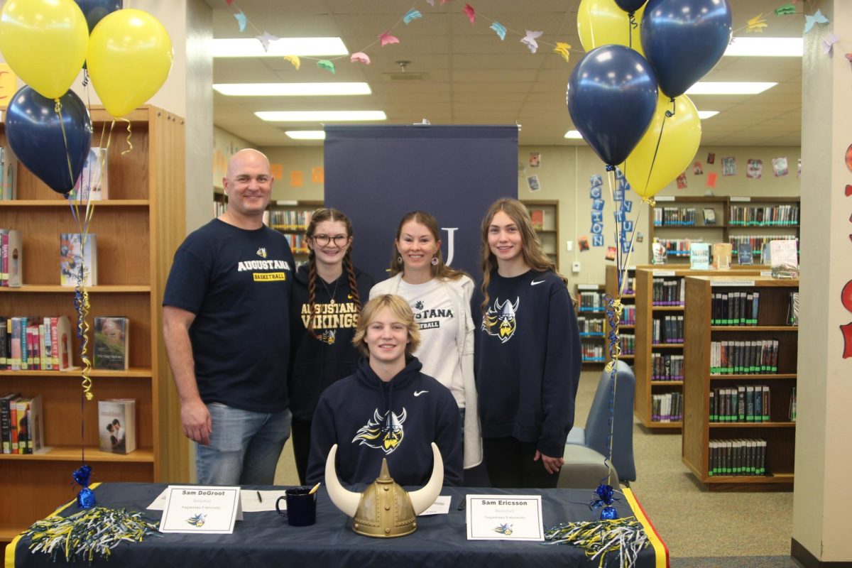 Sam DeGroot sits with his family after signing with Augustana University on Nov. 12, 2025.