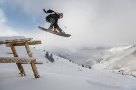Snowboarder jumping from an avalanche fence (Photo used with permission by Pexels).