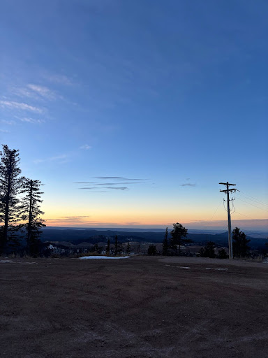 A warm sunset captures the silhouette of the Black Hills mountains seen from the top of Terry Peak summit.
