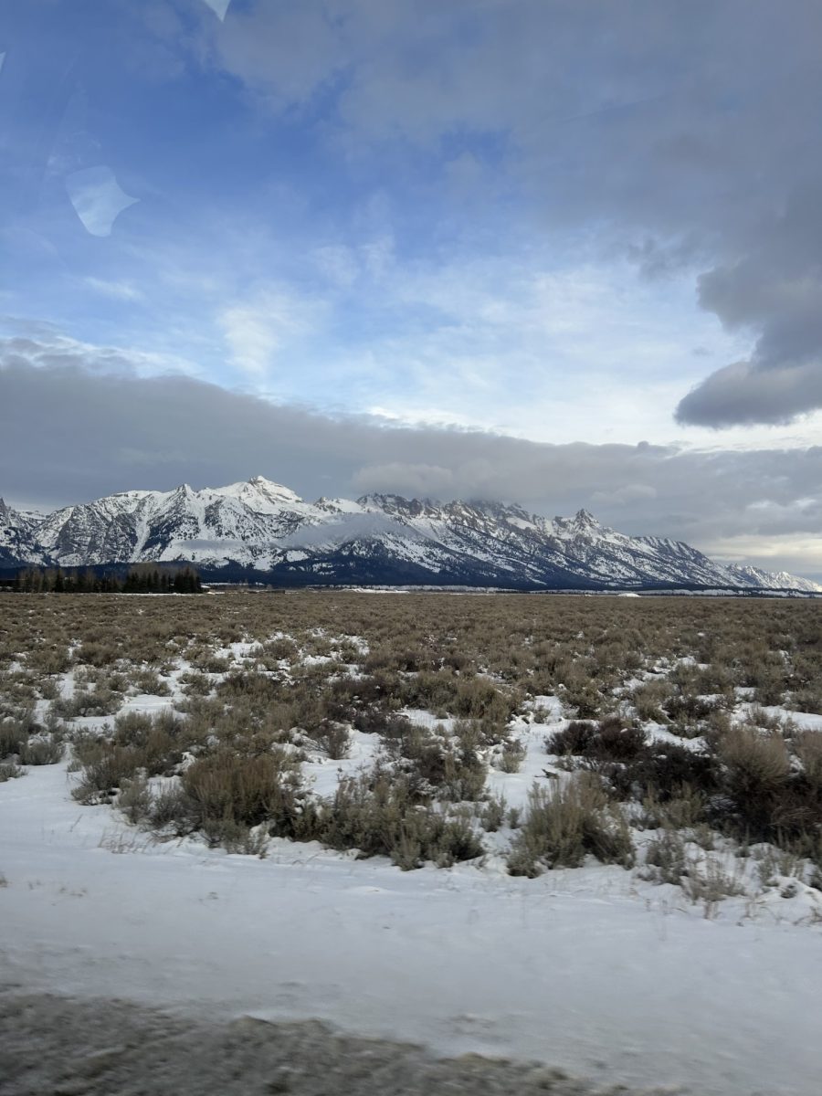 The Teton Mountain range with a cloud veil covering the peaks of the mountains.