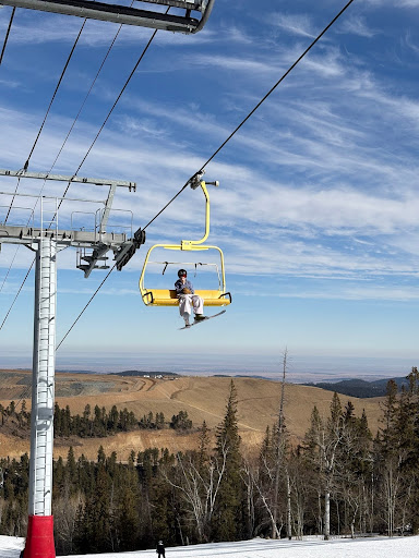 A view of Sam Barnett on the yellow chairlift at Terry Peak.